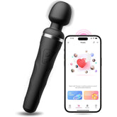 A black handheld Lovense Domi 2 Bluetooth App Controlled Wand Vibrator and a smartphone displaying an app. The massager, which is the Lovense Domi 2, has a rounded head and buttons on its handle. The smartphone screen features colorful icons and a heart symbol, indicating Bluetooth compatibility and connectivity features.